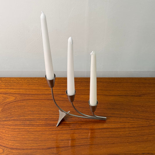 A stainless steel modernist candlestick