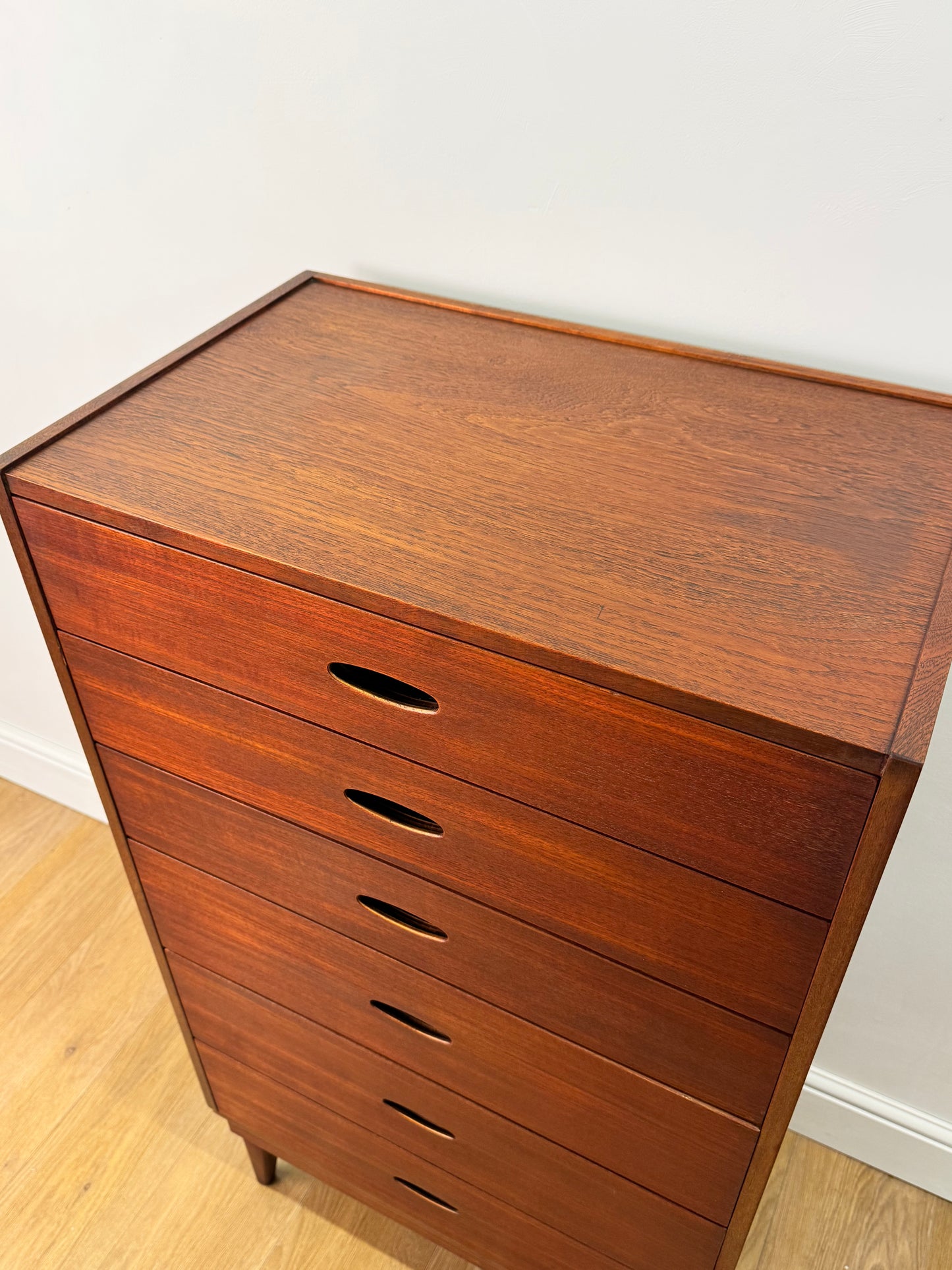 Tall teak chest of drawers by Frank Guille