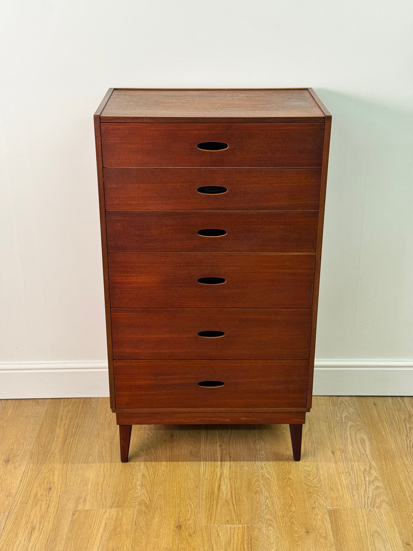 Tall teak chest of drawers by Frank Guille