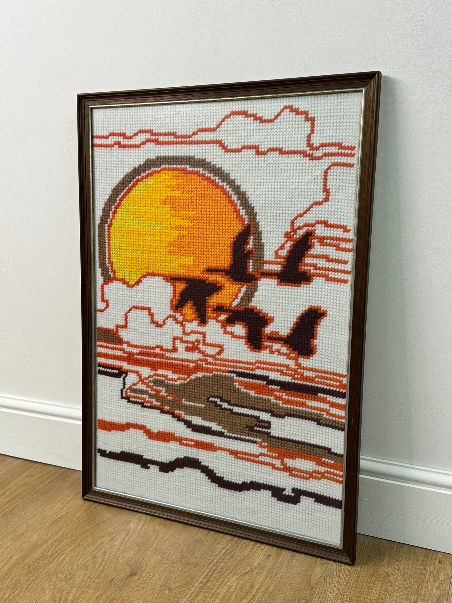 1970s tapestry picture of flying geese in a sunset