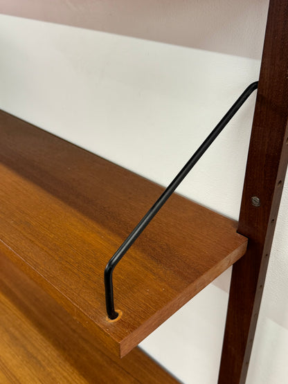Danish teak wall mounted shelving system by Poul Cadovious