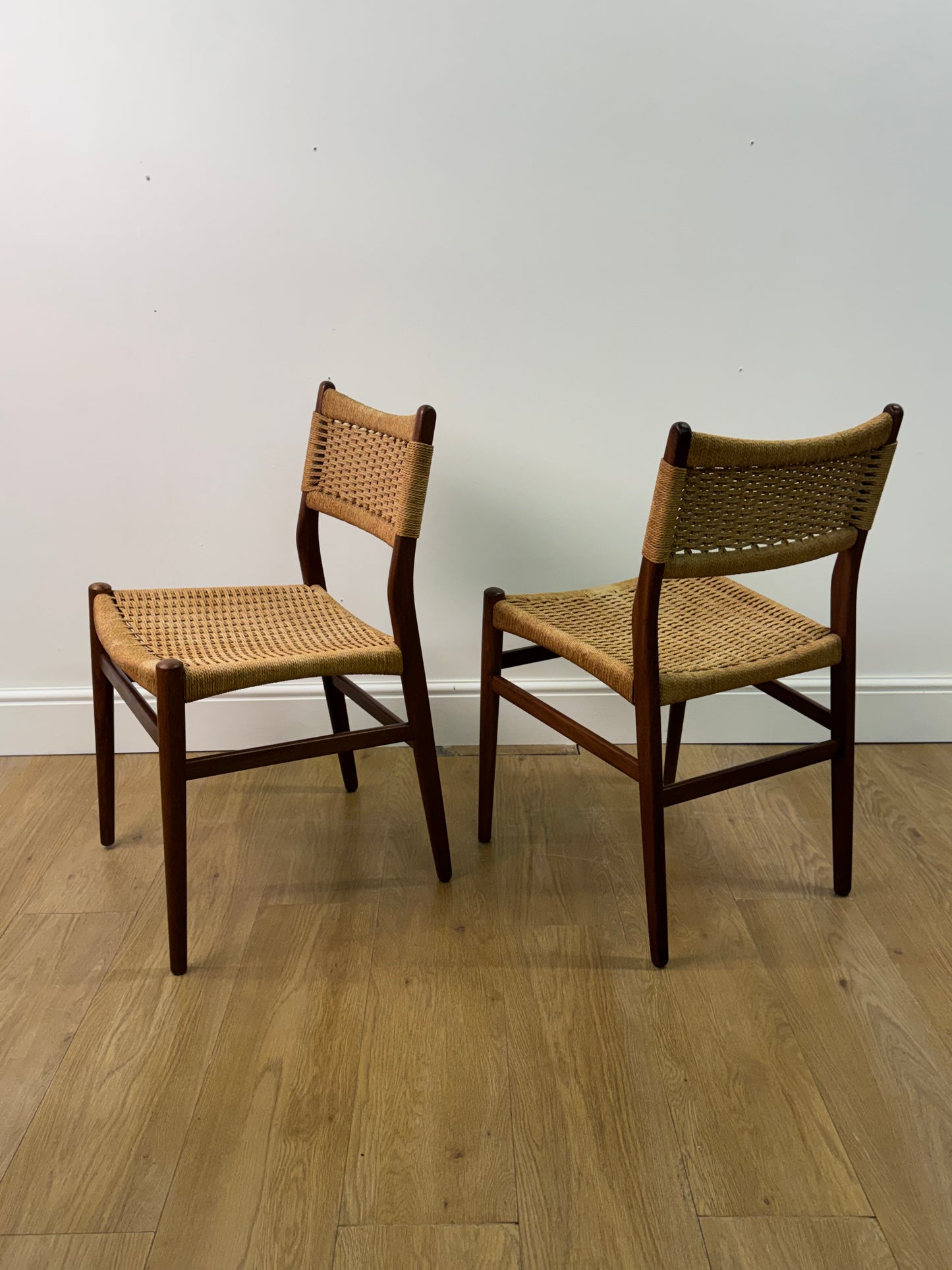 Set of two Danish teak dining chairs with corded seats