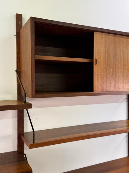 Danish teak wall mounted shelving system by Poul Cadovious