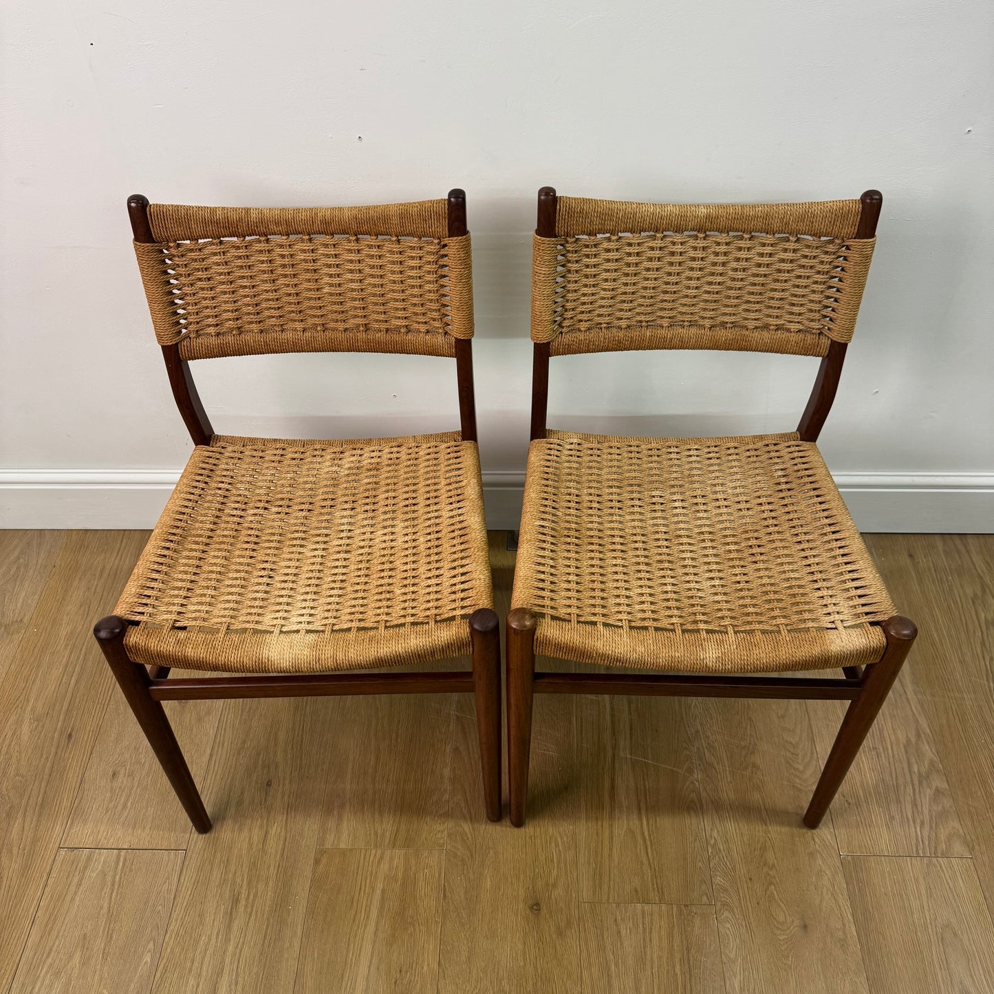 Set of two Danish teak dining chairs with corded seats