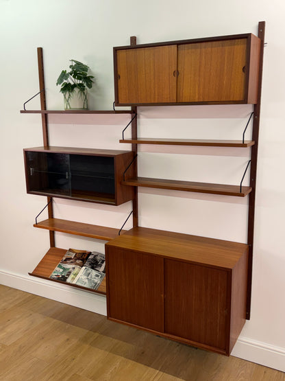 Danish teak wall mounted shelving system by Poul Cadovious