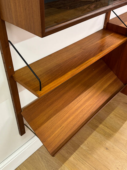 Danish teak wall mounted shelving system by Poul Cadovious