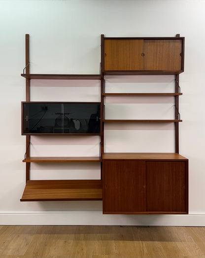 Danish teak wall mounted shelving system by Poul Cadovious