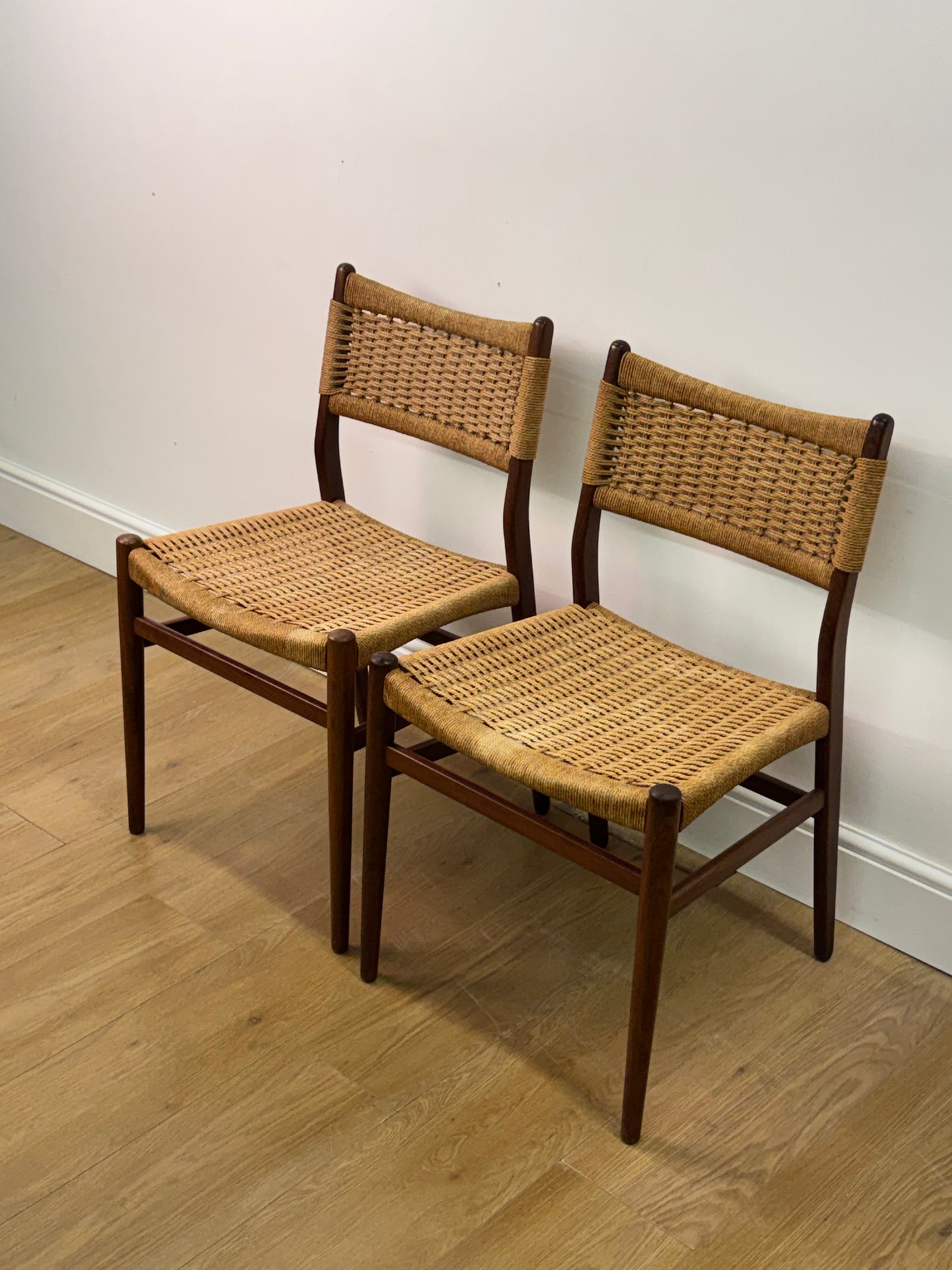 Set of two Danish teak dining chairs with corded seats